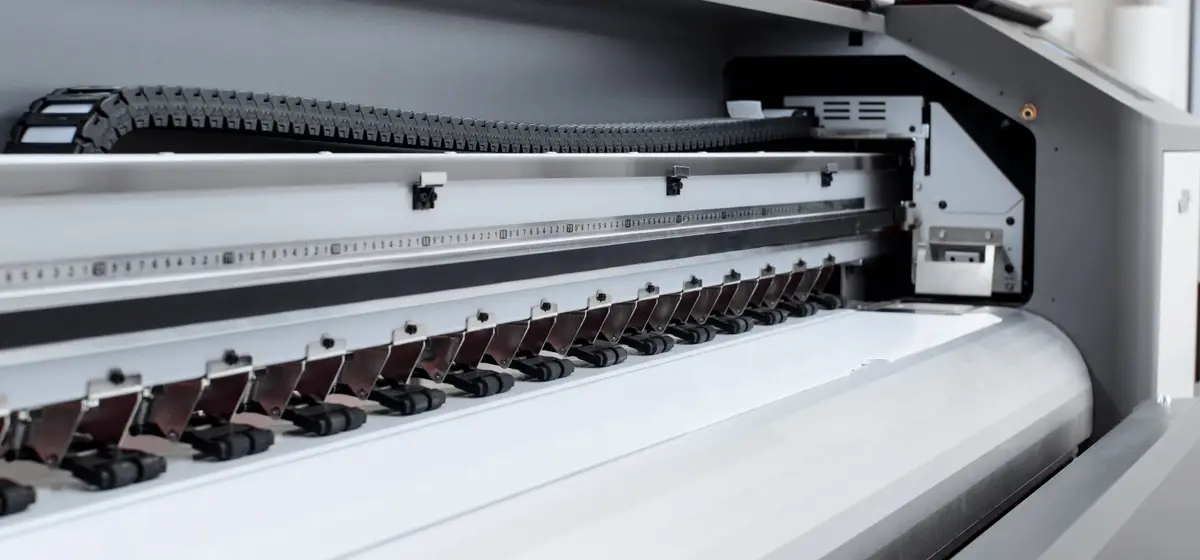 The print carriage and rollers of a large-format inkjet printer