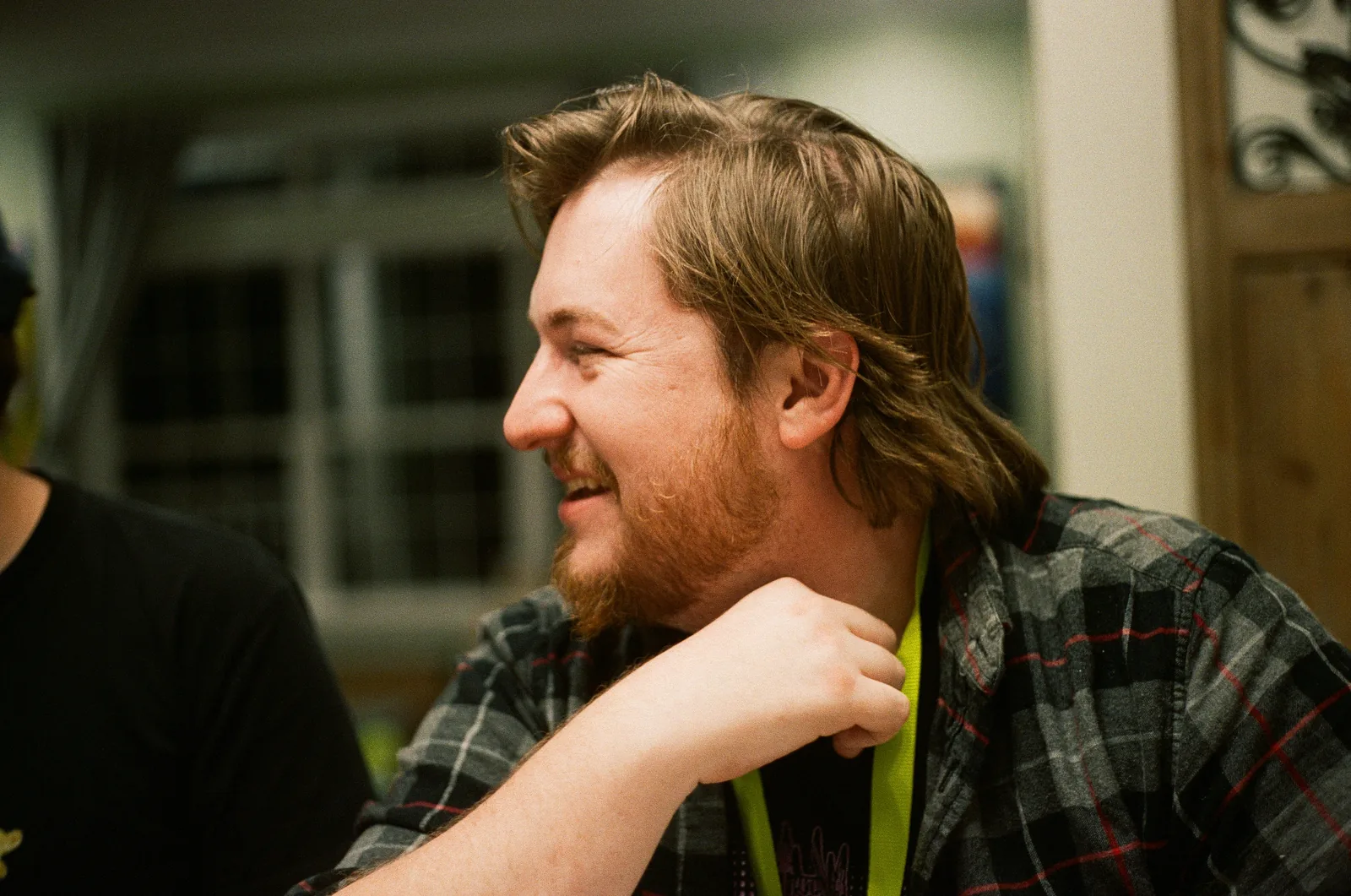 Mike Allen, laughing, in a plaid shirt